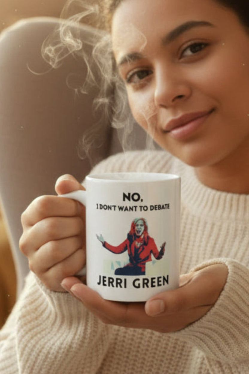 Latina woman holding a white mug with a Marsha Blackburn graphic and the text 'No, I don't want to debate Jerri Green' in black text, sitting in a cozy living room.