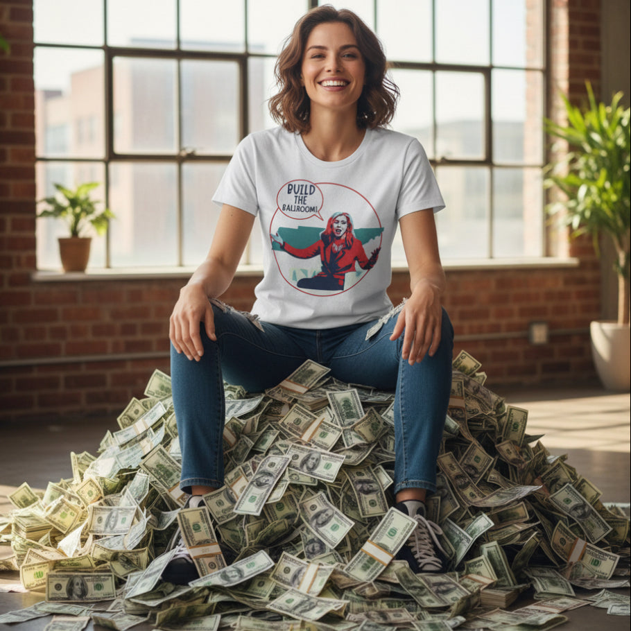 White woman wearing a white t-shirt with a graphic design of Marsha Blackburn with a speech bubble that says  'Build the Ballroom' on a white background