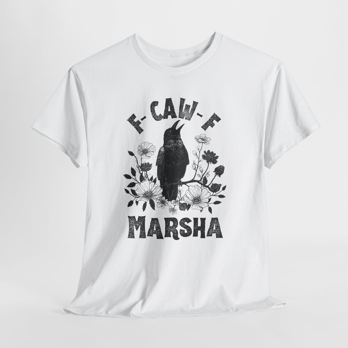 Woman in a forest with crows around, wearing a t-shirt with a bird design and text.